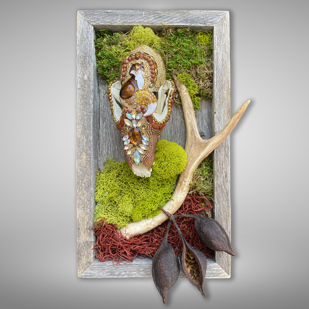 Mosaic embellished fox skull assemblage featuring rhinestone jewels and goldstone set into a barn wood frame with moss, antler, seed pods.